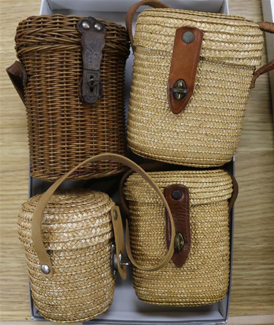 Four travelling glasses in wicker containers